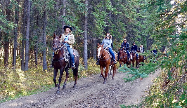 women riding horses on a trail having no control