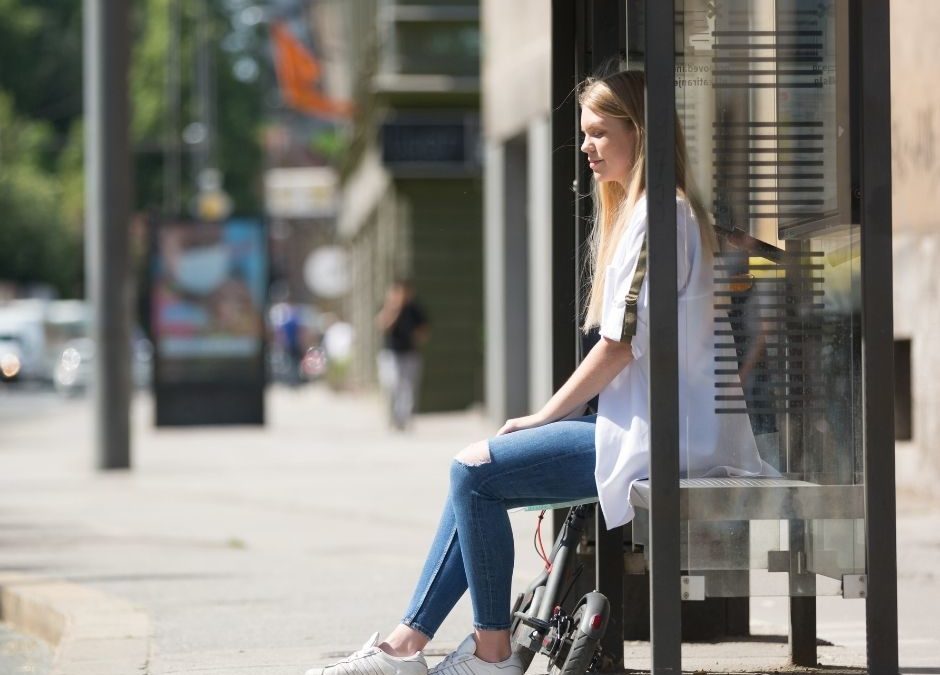 woman sitting at bus stop